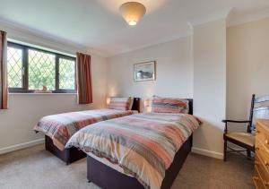 a bedroom with two beds and a window at Moraine in Ravenscar