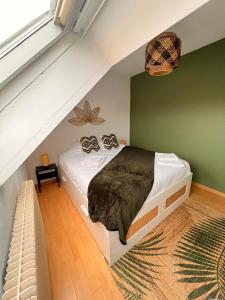 a bedroom with a bed in a attic at Balnéo, Lumineux, Confort in Colmar