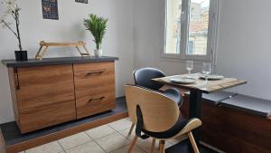 a dining room with a table and chairs and a dresser at Bed To Rent - Maison Calme avec Jacuzzi sous Supplément in Bordeaux