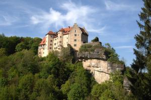 a castle perched on top of a mountain at Burg Rabenstein in Kirchahorn