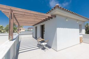 a white house with a wooden pergola at Napa Sunlight Villa #2 in Ayia Napa