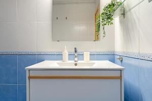 a bathroom with a white sink and a mirror at Center Beach Calafell in Calafell +16 photos