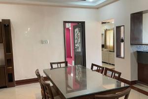 a dining room with a glass table and chairs at Aesthetic, beautiful & Furnished in Bellary +17 photos