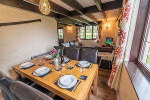 a dining room with a table and chairs at Lakeside Cottage in Woolacombe