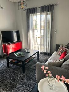 a living room with a couch and a coffee table at Beautiful apartment next to metro station in Athens