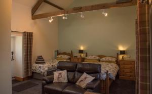 a bedroom with a bed and a couch at Wydon Farm Bed and Breakfast in Haltwhistle