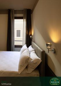 Ένα ή περισσότερα κρεβάτια σε δωμάτιο στο Hotel Palazzo Paradiso