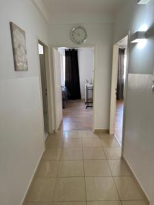 a hallway with a clock on the wall and a clock at Schöne Wohnung mit Balkon in Vienna +2 photos