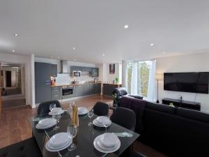 a living room with a table with plates on it at Luxury Dockview 3 Beds Excel London in London