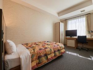 Voodi või voodid majutusasutuse Gamagori Hotel toas