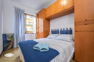 a bedroom with a large bed with blue towels on it at La casa del marinaio in Genova