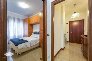 a bedroom with a bed and a door to a hallway at La casa del marinaio in Genova