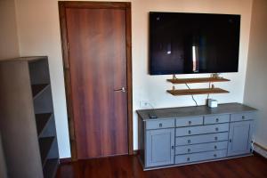 TV at/o entertainment center sa Comfortable 4-Room Apartments in Jekabpils