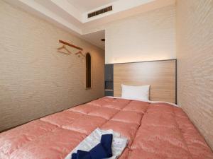 Voodi või voodid majutusasutuse Gamagori Hotel toas