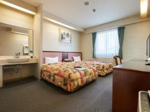 Voodi või voodid majutusasutuse Gamagori Hotel toas