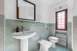 a bathroom with a sink and a toilet and a mirror at -Ethnic Design Loft- con soppalco [Città Studi M2] in Milan