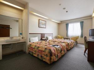 Voodi või voodid majutusasutuse Gamagori Hotel toas