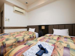 Voodi või voodid majutusasutuse Gamagori Hotel toas