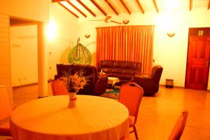 a living room with a table and a couch at The Kings Villa. in Wattala +21 photos