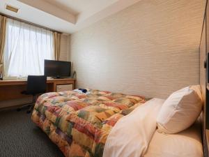 Voodi või voodid majutusasutuse Gamagori Hotel toas