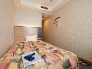 Voodi või voodid majutusasutuse Gamagori Hotel toas