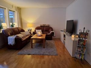 a living room with two couches and a coffee table at House in Trångsund, 15 min south of Stockholm, free parking, in Trångsund