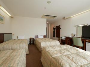 Voodi või voodid majutusasutuse Gamagori Hotel toas
