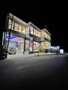 a building with a car parked in front of it at Hotel Nature’s View Dharamshala in Dharamshala