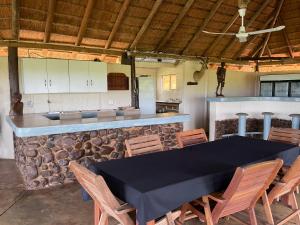 una cucina con tavolo, sedie e bancone di Letaba Waterfront Lodge a Letaba Wildlife Reserve