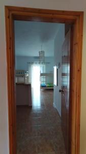 a kitchen with a door open to a room at Oasis Hostel in Himare