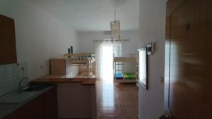 a kitchen with boxes on the floor and a refrigerator at Oasis Hostel in Himare