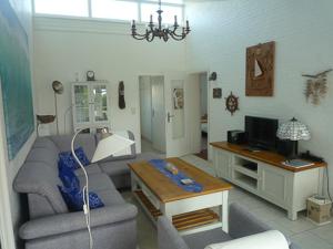 a living room with a couch and a table at Ferienhaus Treibholz in Neuharlingersiel