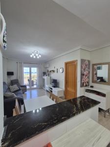 a kitchen and living room with a counter top at Vista al Mar with Parking Space in La Mata
