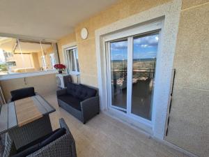 a living room with a view of a balcony at Vista al Mar with Parking Space in La Mata