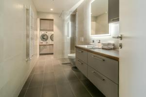 a bathroom with a toilet and a sink at Sif Apartments by Heimaleiga in Reykjavík