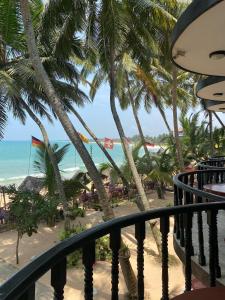 a view of the beach from the balcony of a resort at WASANA beach hotel in Induruwa