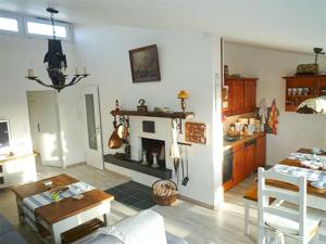 a living room with a fireplace and a dining room at Ferienhaus Treibholz II in Neuharlingersiel