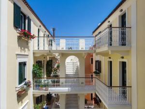 een afbeelding van een appartementencomplex met balkons bij Filoxenia Kirki Apartments by CorfuEscapes in Benitses
