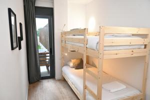 a room with two bunk beds and a window at Homenfun Barcelona Can Serra in Hospitalet de Llobregat