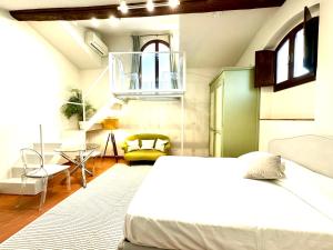 um quarto com uma cama, uma mesa e uma cadeira em Palazzo Pandolfini's City-View Studios em Florença