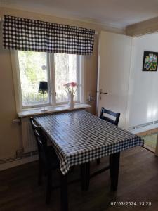 a dining room table with a checkered table cloth on it at Molidens Gästgiveri Jönköping in Jönköping