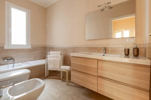 a bathroom with a white sink and a mirror at Balconcino sul Rivellino by BarbarHouse in Gallipoli +25 photos
