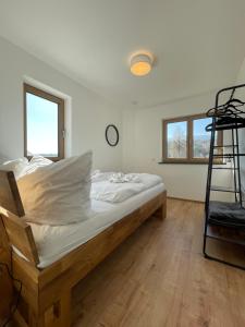 タイゼンドルフにあるFerienwohnungen Vogelauのベッドルーム1室(白いシーツとはしご付きのベッド1台付)