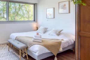 a bedroom with two beds and a window at A3 - 2 BDR Sea View 10 min Beach - Parking, Pool & Terrace in Antibes +36 photos