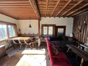 a living room with a couch and a table at Casa dos Toros in Cortes do Meio