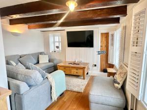 a living room with a couch and a tv at Harbourside in Staithes