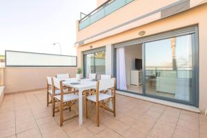 a dining room with a table and chairs on a balcony at Atardecer en Sanlúcar in Sanlúcar de Barrameda