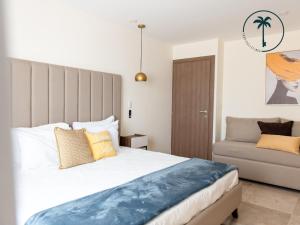 a bedroom with a large bed and a couch at Moderno condominio con vista al mar! in Mazatlán +31 photos