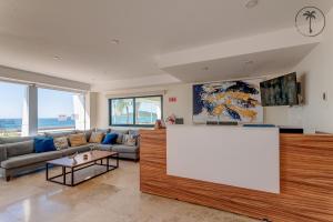 a living room with a couch and a large white screen at Hermosa Vista al Mar, Condominio de Lujo! in Mazatlán