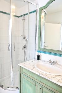 a bathroom with a sink and a shower at Villa Giulia in SantʼAgata sui Due Golfi